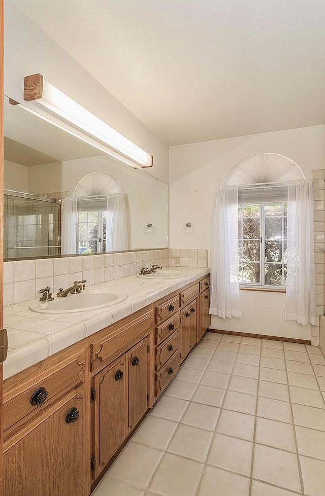 bathroom with tile patterned floors, vanity, and decorative backsplash