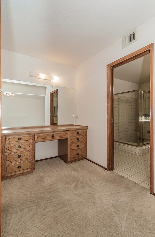 bathroom featuring a shower with door and vanity