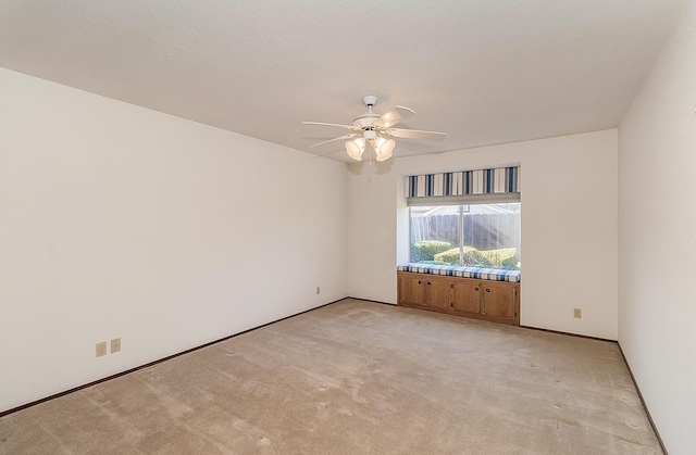 carpeted empty room with a textured ceiling and ceiling fan