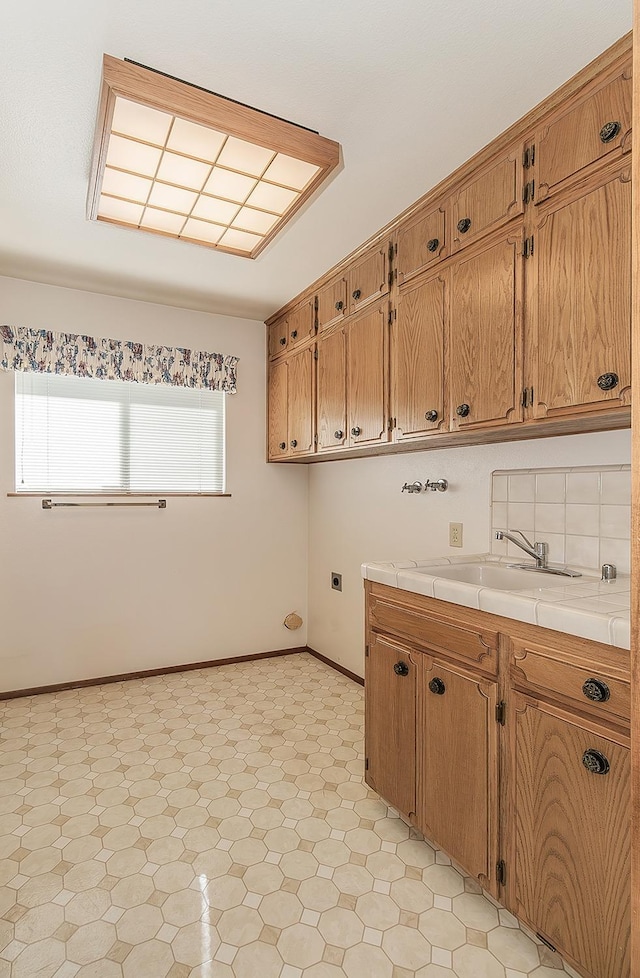 kitchen with tasteful backsplash, sink, and tile countertops