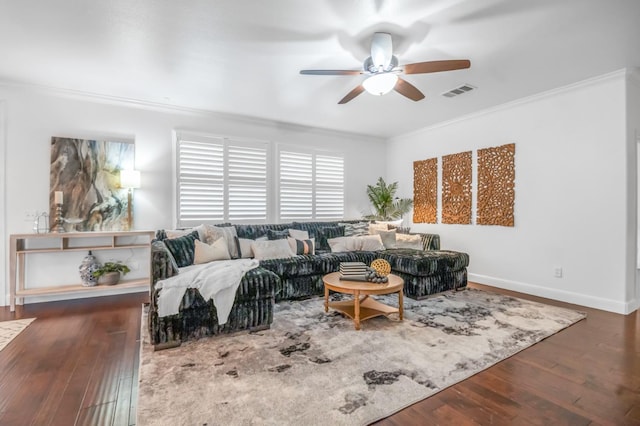 living room with visible vents, hardwood / wood-style flooring, crown molding, baseboards, and ceiling fan