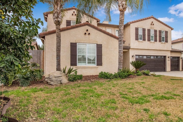 mediterranean / spanish-style home with a garage and a front yard