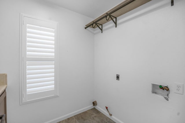 laundry area with baseboards, washer hookup, laundry area, hookup for a gas dryer, and hookup for an electric dryer