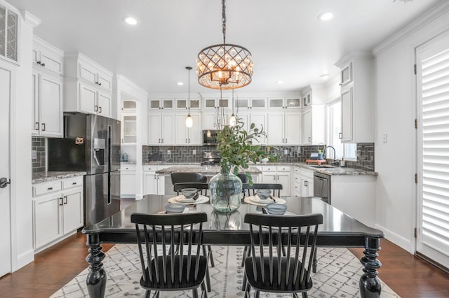 dining room featuring recessed lighting, baseboards, an inviting chandelier, and dark wood-style flooring
