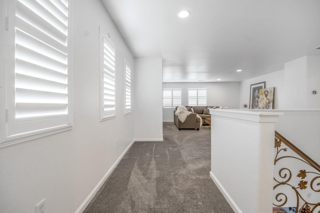 corridor with recessed lighting, baseboards, an upstairs landing, and carpet flooring