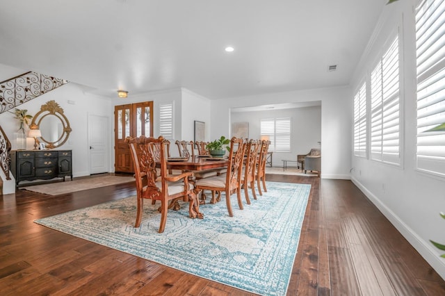 dining area featuring visible vents, baseboards, and dark wood-style flooring