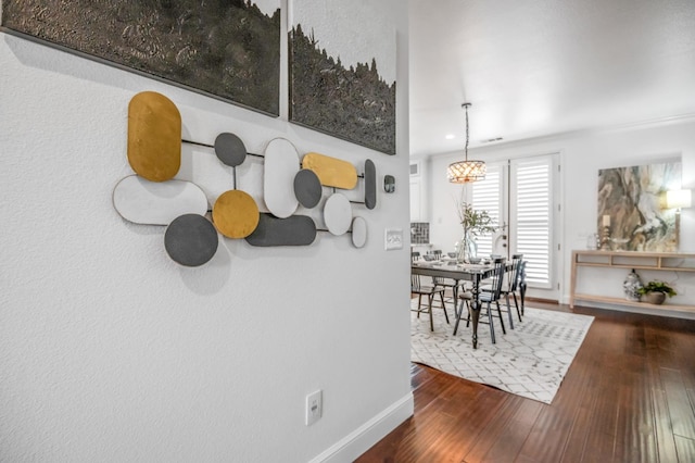 dining room featuring baseboards and wood-type flooring