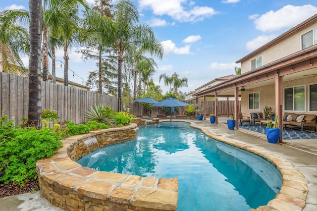 view of pool with a ceiling fan, a fenced in pool, a fenced backyard, outdoor lounge area, and a patio area