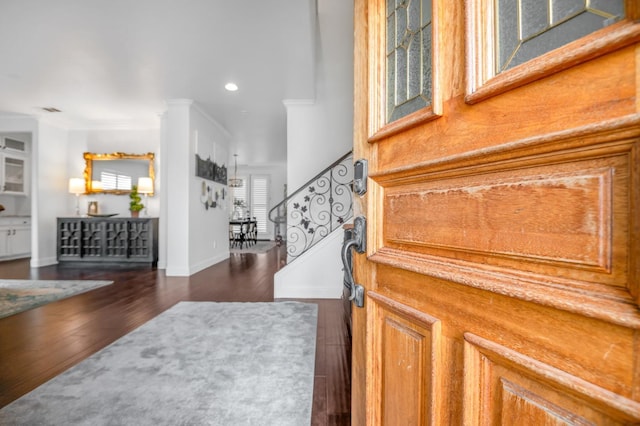 foyer with ornamental molding, stairs, recessed lighting, baseboards, and dark wood-style flooring