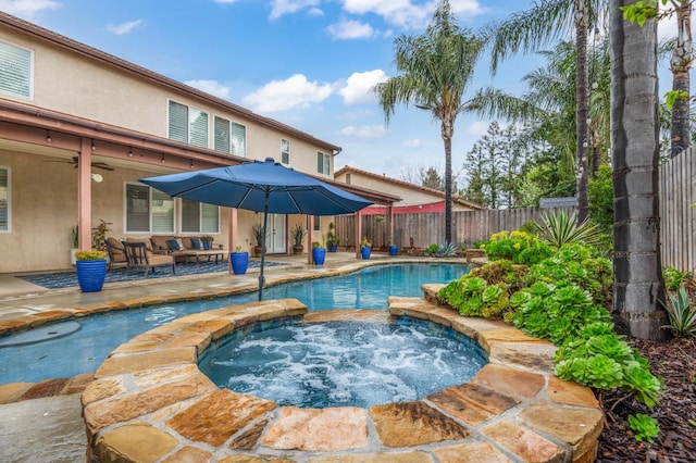 view of pool with ceiling fan, an in ground hot tub, a fenced backyard, and a patio area