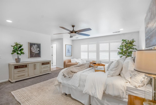 bedroom with ceiling fan, baseboards, visible vents, and light carpet