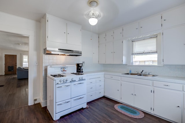 kitchen with sink, dark hardwood / wood-style floors, tasteful backsplash, white cabinets, and range with two ovens