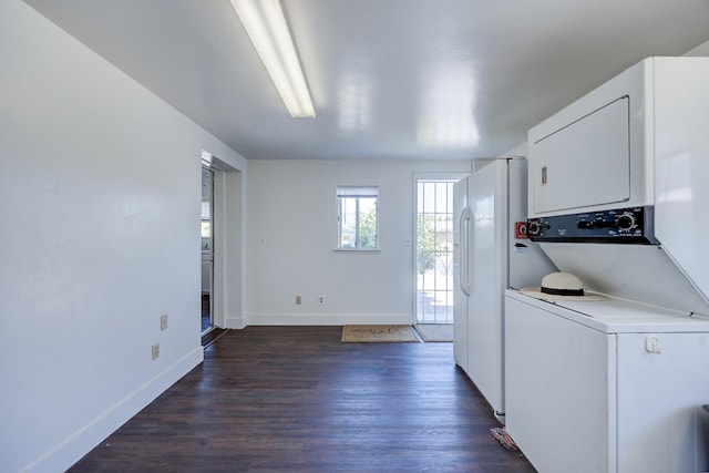 laundry area featuring dark hardwood / wood-style flooring and stacked washing maching and dryer