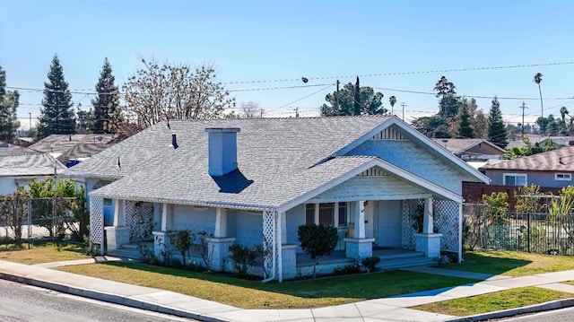 view of front facade with covered porch and a front lawn