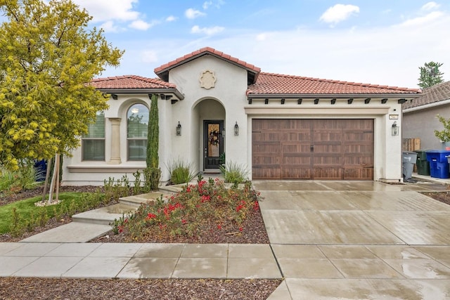 mediterranean / spanish home featuring a garage