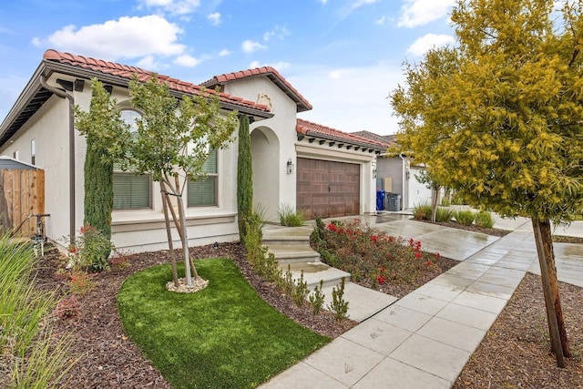 mediterranean / spanish-style home with a garage