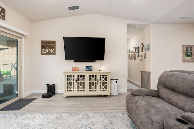 living room with lofted ceiling and radiator