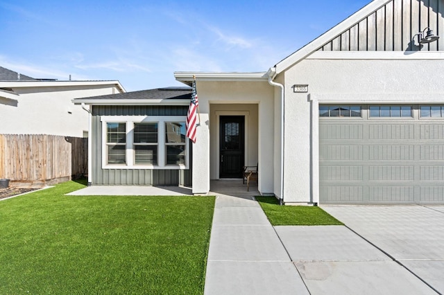 doorway to property featuring a garage and a lawn