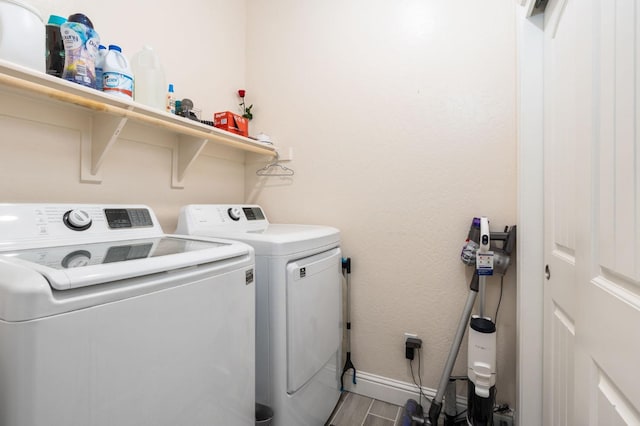 laundry area featuring separate washer and dryer and hardwood / wood-style floors