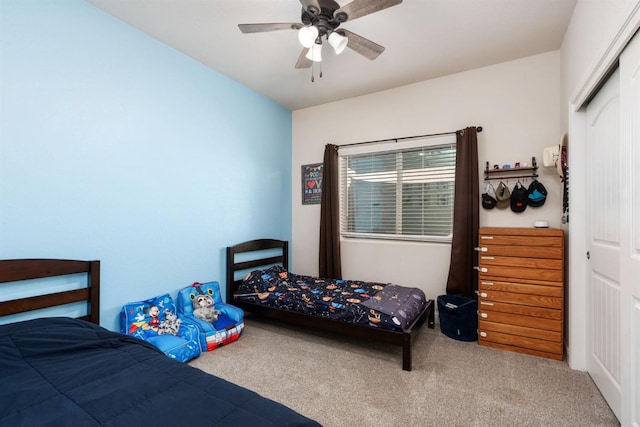 bedroom featuring carpet flooring, ceiling fan, and a closet