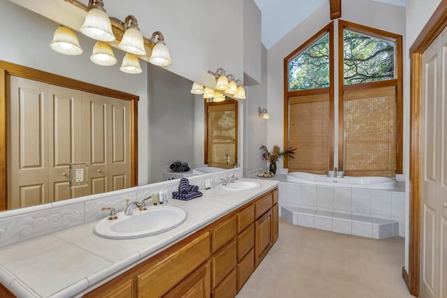 bathroom with vanity and tiled bath