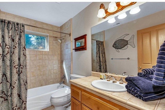 full bathroom with vanity, shower / tub combo, and toilet