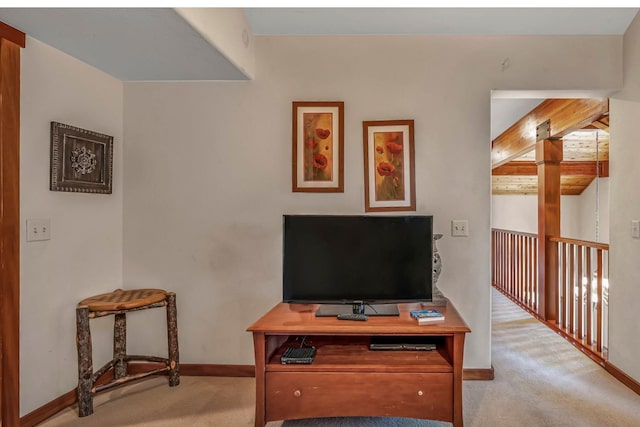 interior space with beam ceiling and light carpet