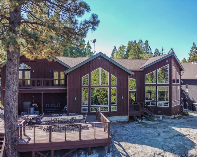 rear view of house featuring a wooden deck