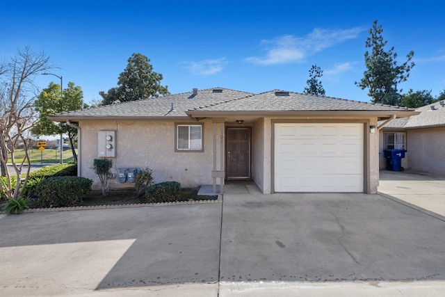 view of front of home featuring a garage, concrete driveway, a shingled roof, and stucco siding