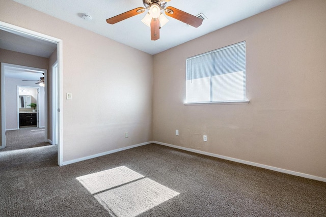 spare room with carpet floors, baseboards, and a ceiling fan