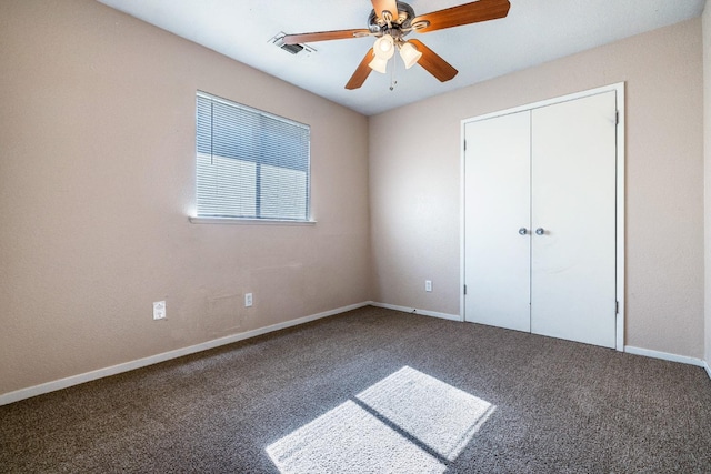 unfurnished bedroom with a ceiling fan, baseboards, visible vents, and carpet flooring