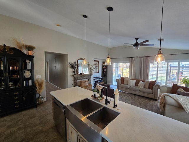 kitchen with dishwasher, vaulted ceiling, sink, and pendant lighting