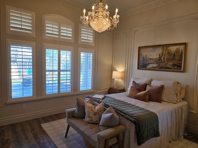 bedroom featuring crown molding, an inviting chandelier, and hardwood / wood-style floors