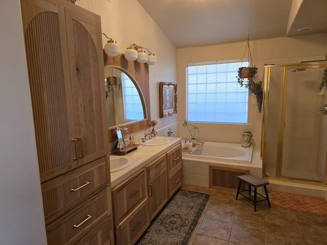 bathroom with lofted ceiling, a healthy amount of sunlight, plus walk in shower, and vanity