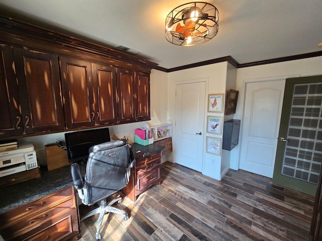 office area featuring crown molding, built in desk, and dark hardwood / wood-style floors