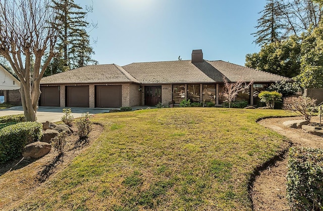 ranch-style home featuring a garage and a front yard