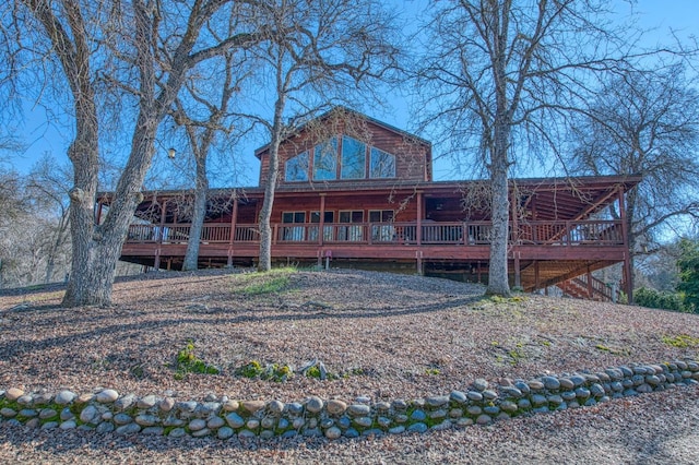 rear view of property with a wooden deck