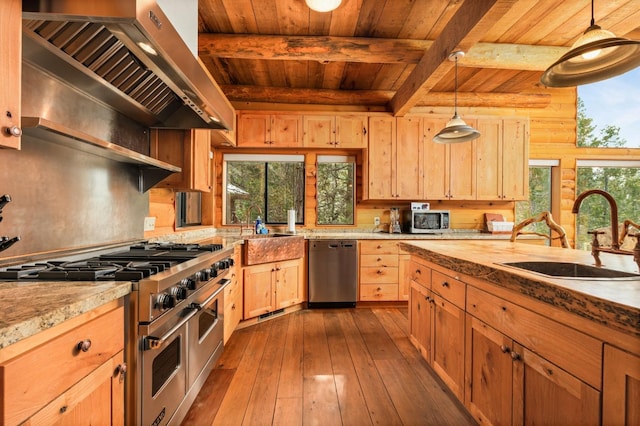 kitchen featuring decorative light fixtures, sink, light brown cabinets, stainless steel appliances, and wall chimney range hood