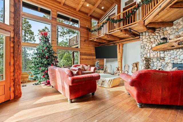 living room with wood ceiling, light hardwood / wood-style flooring, high vaulted ceiling, and a healthy amount of sunlight