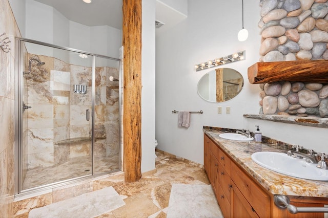 bathroom featuring toilet, vanity, and walk in shower