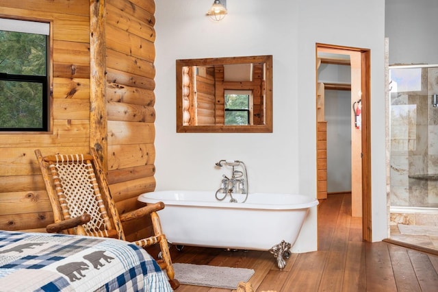 bedroom with wood-type flooring and rustic walls