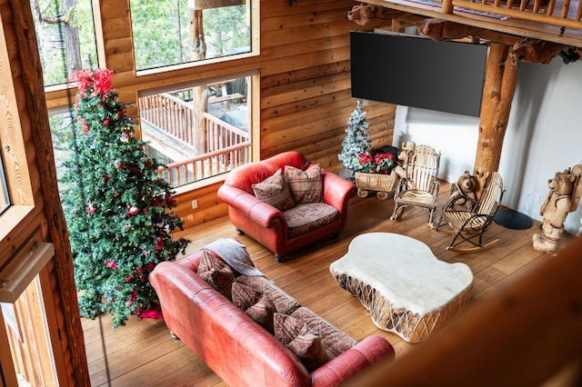 living room with hardwood / wood-style flooring and wooden walls