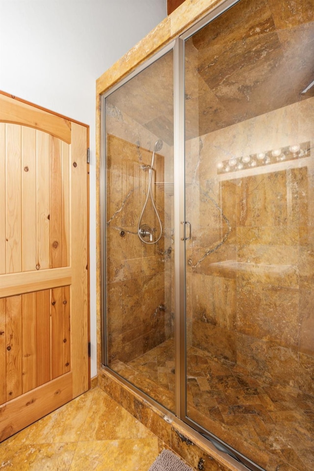 bathroom with a shower with shower door