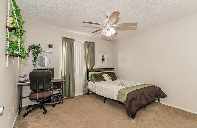 carpeted bedroom with ceiling fan and a textured ceiling