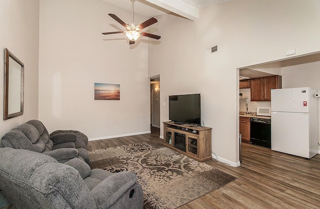 living room with high vaulted ceiling, sink, dark hardwood / wood-style flooring, ceiling fan, and beam ceiling