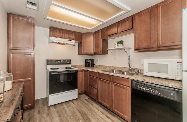 kitchen featuring sink, white appliances, and light hardwood / wood-style floors