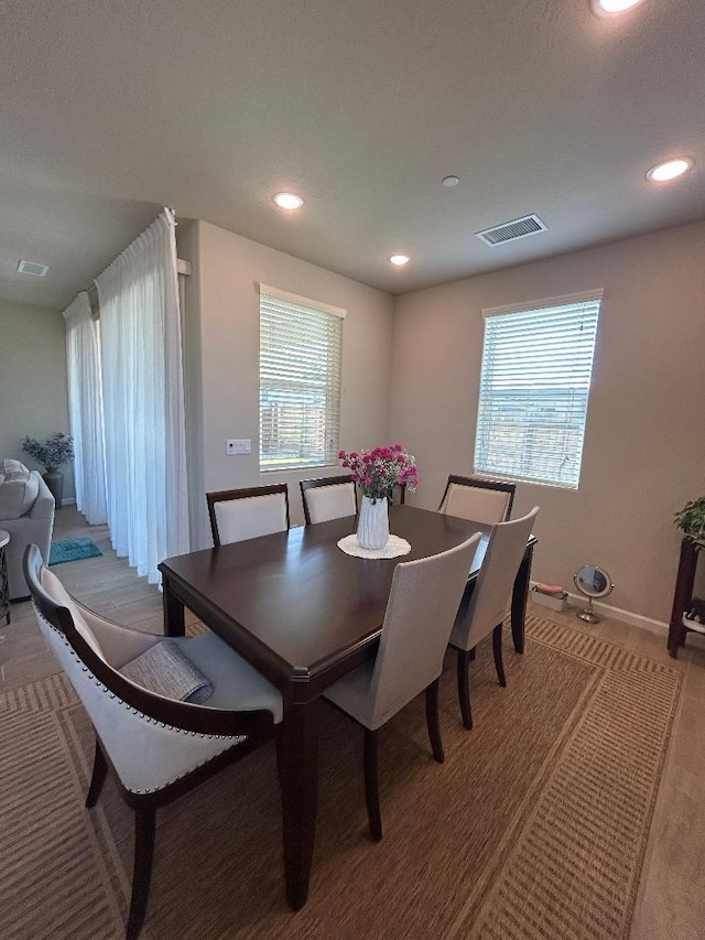 dining space featuring a healthy amount of sunlight and light carpet