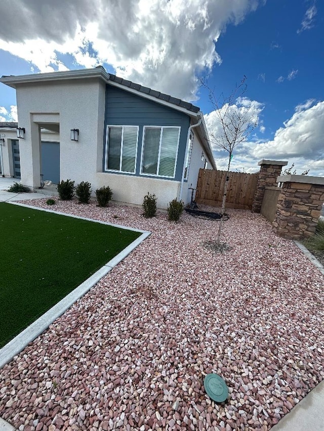 view of side of property with a lawn