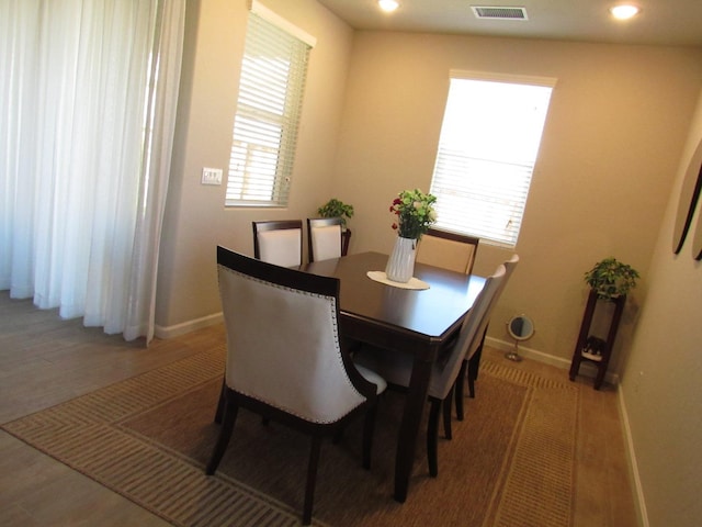 dining room with plenty of natural light and wood-type flooring