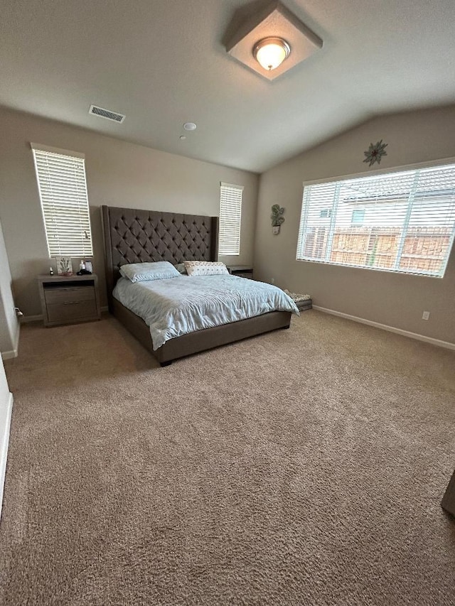 bedroom featuring vaulted ceiling and carpet flooring